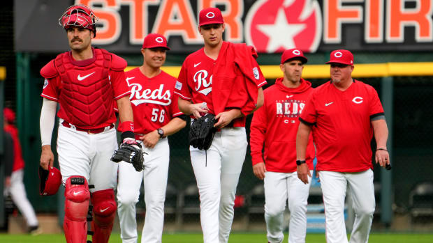 Cincinnati Reds catcher Curt Casali (12), left, and Cincinnati Reds starting pitcher Nick Lodolo (40), center, walk in from the dugout before a baseball game between the Chicago White Sox and the Cincinnati Reds, Saturday, May 6, 2023, at Great American Ball Park in Cincinnati. 